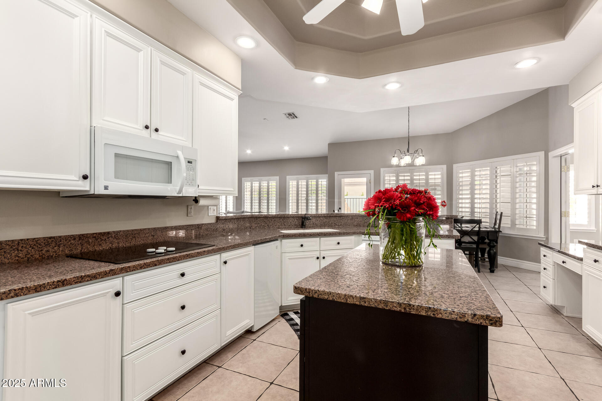 3528 East Decatur Street Mesa, AZ 85213 - Photo 16 of 55 a kitchen with granite countertop a sink cabinets and stainless steel appliances