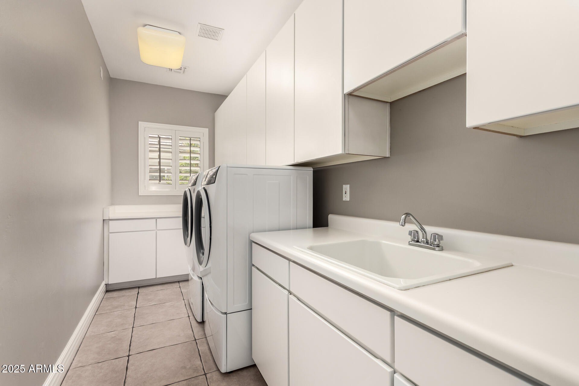 3528 East Decatur Street Mesa, AZ 85213 - Photo 38 of 55 a kitchen with stainless steel appliances a sink a refrigerator and a window