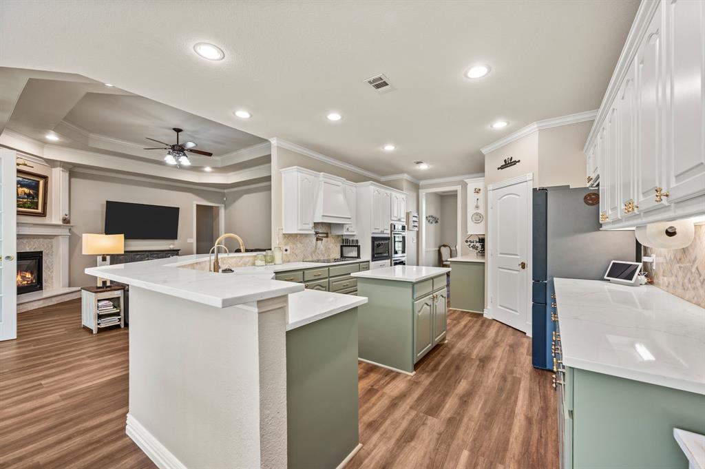 1216 W Road Waxahachie, TX 75165 - Photo 10 of 40 a open kitchen with kitchen island a sink appliances and cabinets
