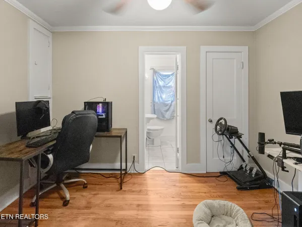 a view of a workspace with furniture and a flat screen tv