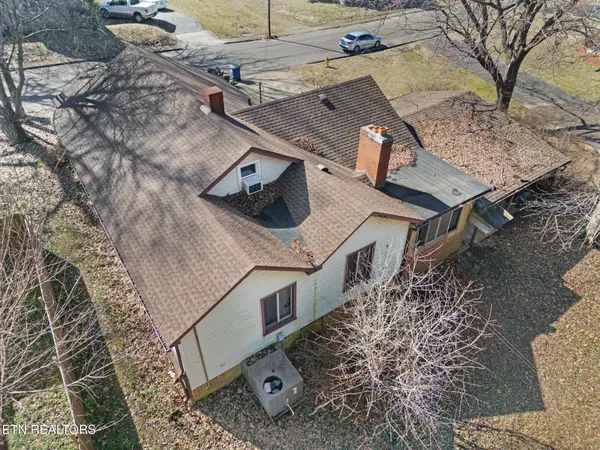 front view of a house with large trees