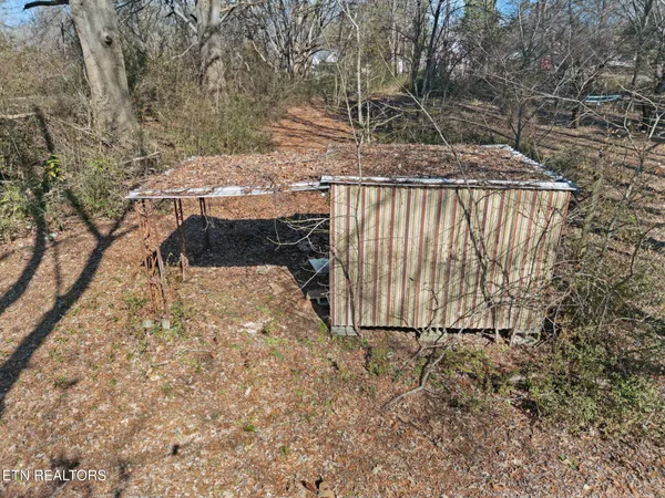 a view of backyard with wooden fence
