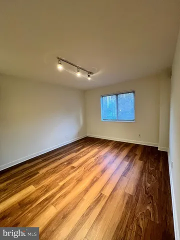 a view of an empty room and wooden floor