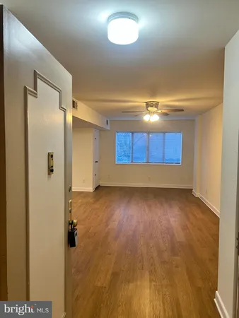 a view of wooden floor and windows in a room