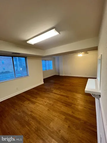 a view of an empty room with wooden floor