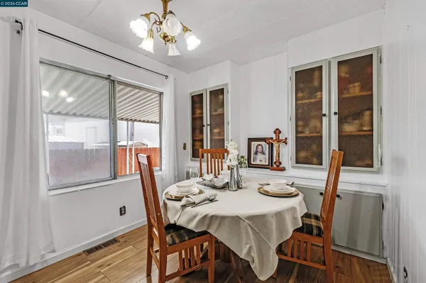 a view of a dining room with furniture window and wooden floor