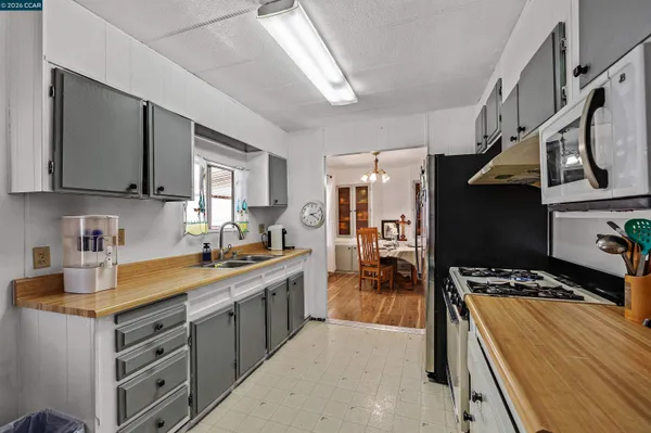 a kitchen with a refrigerator and a sink
