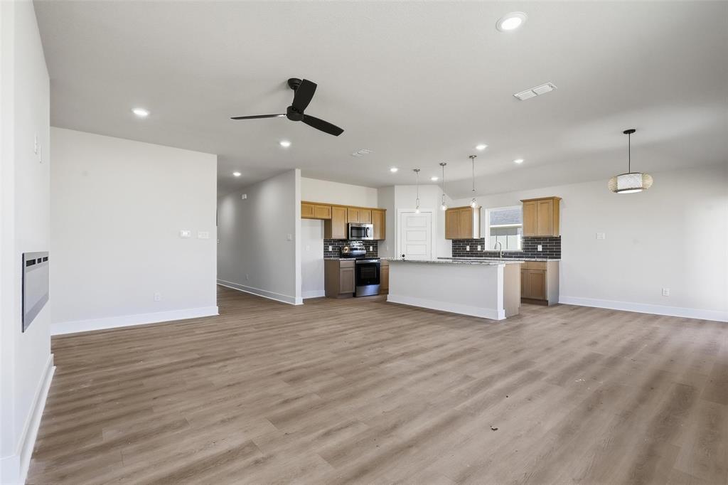 472 Peace Lily Way Tolar, TX 76476 - Photo 16 of 40 a view of a kitchen with a sink and dishwasher white refrigerator with wooden floor