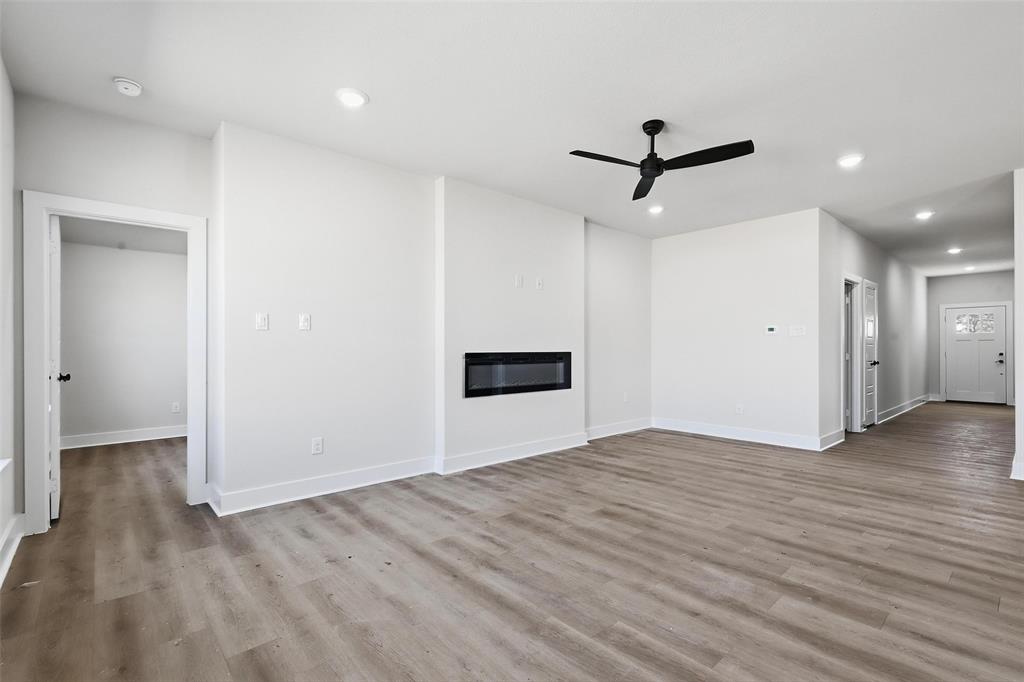 472 Peace Lily Way Tolar, TX 76476 - Photo 17 of 40 an empty room with wooden floor and ceiling fan