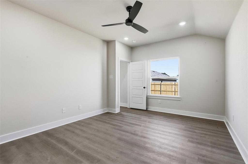 472 Peace Lily Way Tolar, TX 76476 - Photo 19 of 40 a view of an empty room with a window and wooden floor