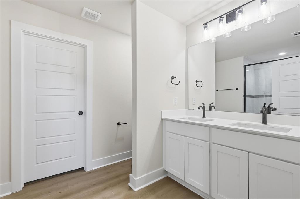 472 Peace Lily Way Tolar, TX 76476 - Photo 21 of 40 a bathroom with a double vanity sink and a mirror