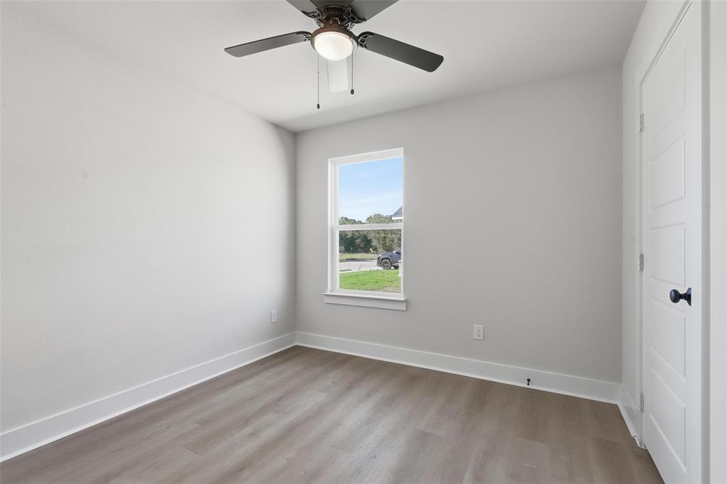 472 Peace Lily Way Tolar, TX 76476 - Photo 27 of 40 an empty room with a window and a fan