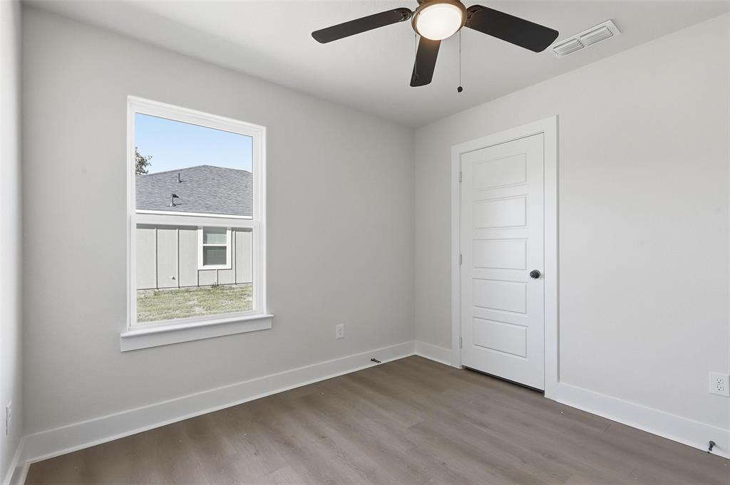 472 Peace Lily Way Tolar, TX 76476 - Photo 29 of 40 a view of an empty room with window and wooden floor