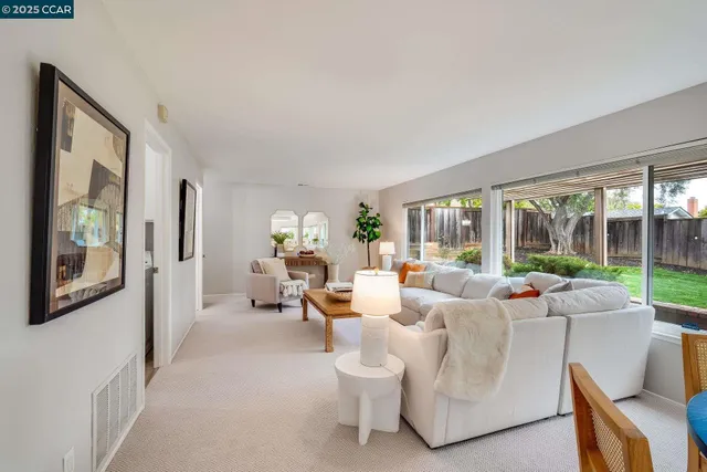 a living room with furniture and large windows