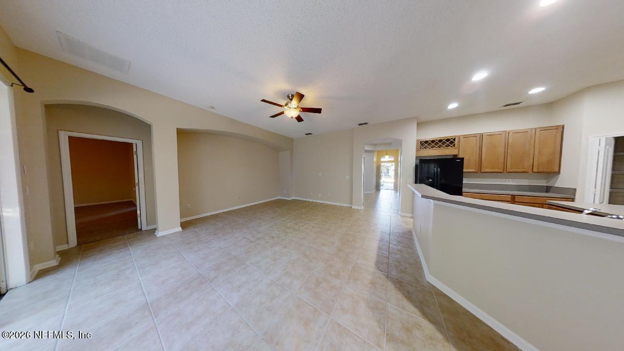 14454 Millhopper Road Jacksonville, FL 32258 - Photo 13 of 44 a view of a kitchen with a sink and a refrigerator