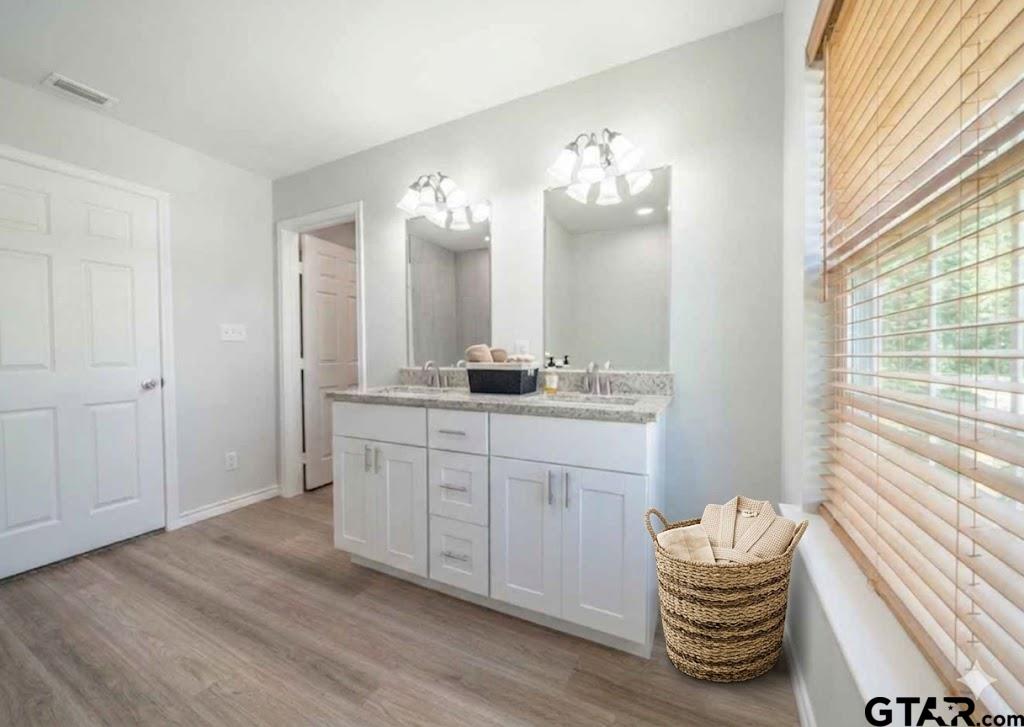 233 Harrison Street Longview, TX 75601 - Photo 43 of 44 a bathroom with a sink and a mirror