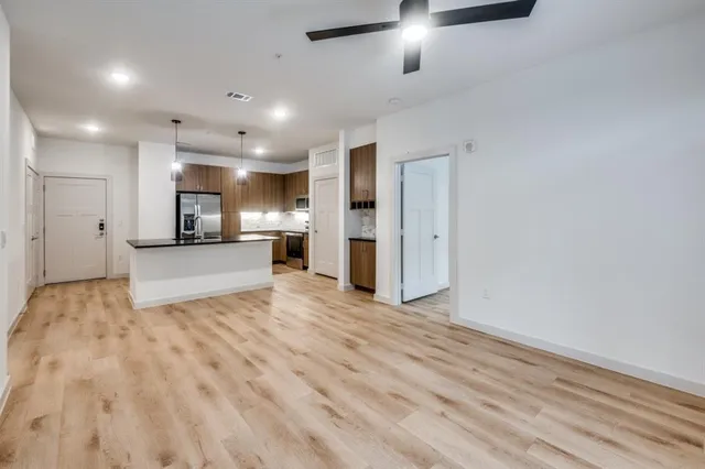 a view of a kitchen with a refrigerator and a sink