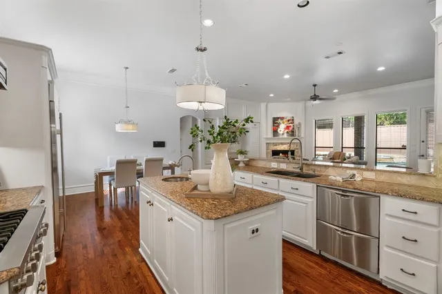 a kitchen with stainless steel appliances granite countertop stove top oven and refrigerator