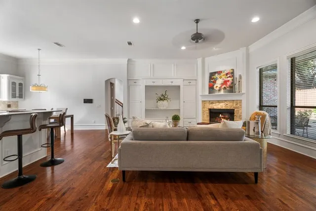 a living room with furniture a fireplace and a flat screen tv