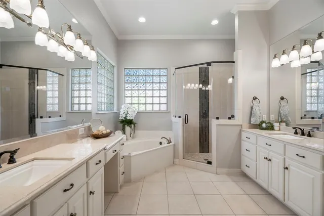 a spacious bathroom with a double vanity sink mirror and a bathtub