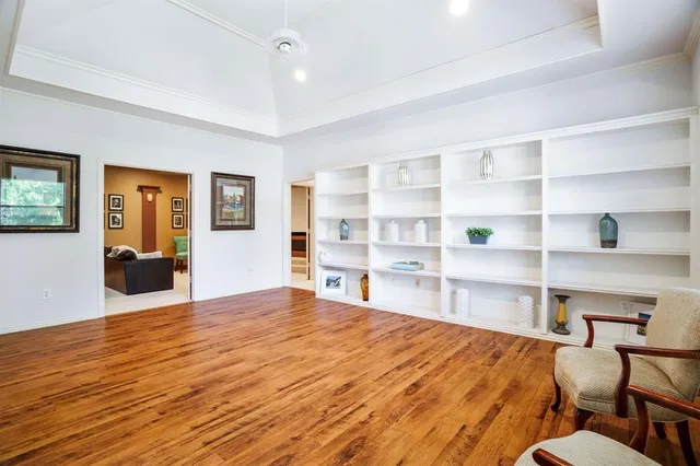 a view of empty room with wooden floor and cabinet
