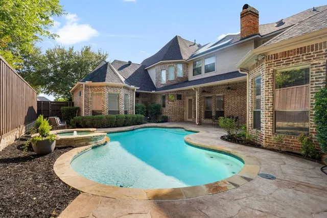 a view of a house with swimming pool and sitting area