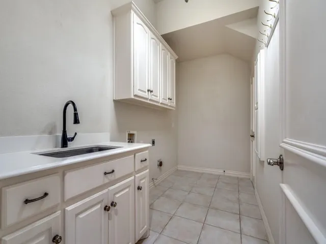 a kitchen with a sink and cabinets