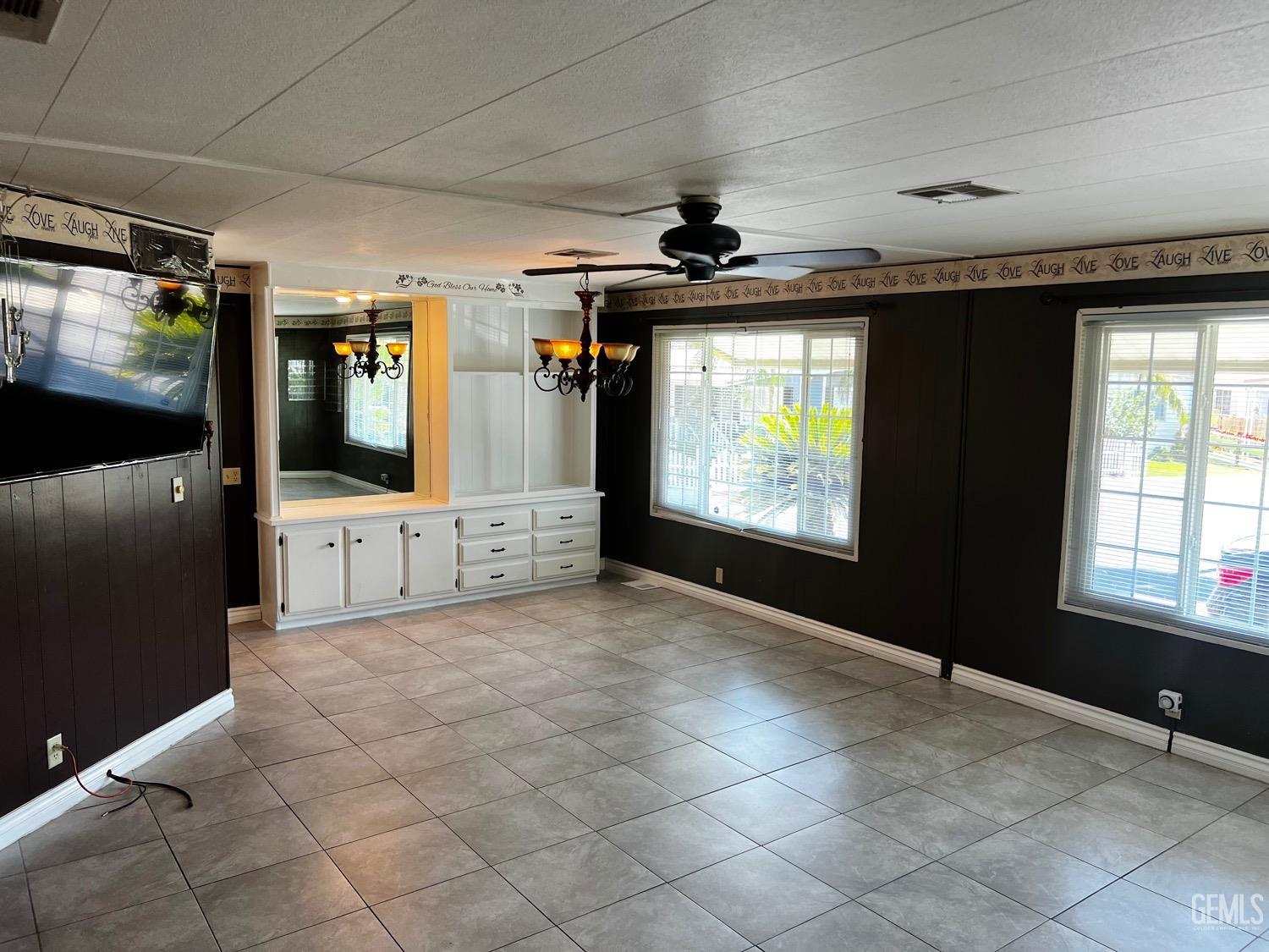 Undisclosed Address Bakersfield, CA 93306 - Photo 2 of 9 a view of a hallway with wooden floor and windows