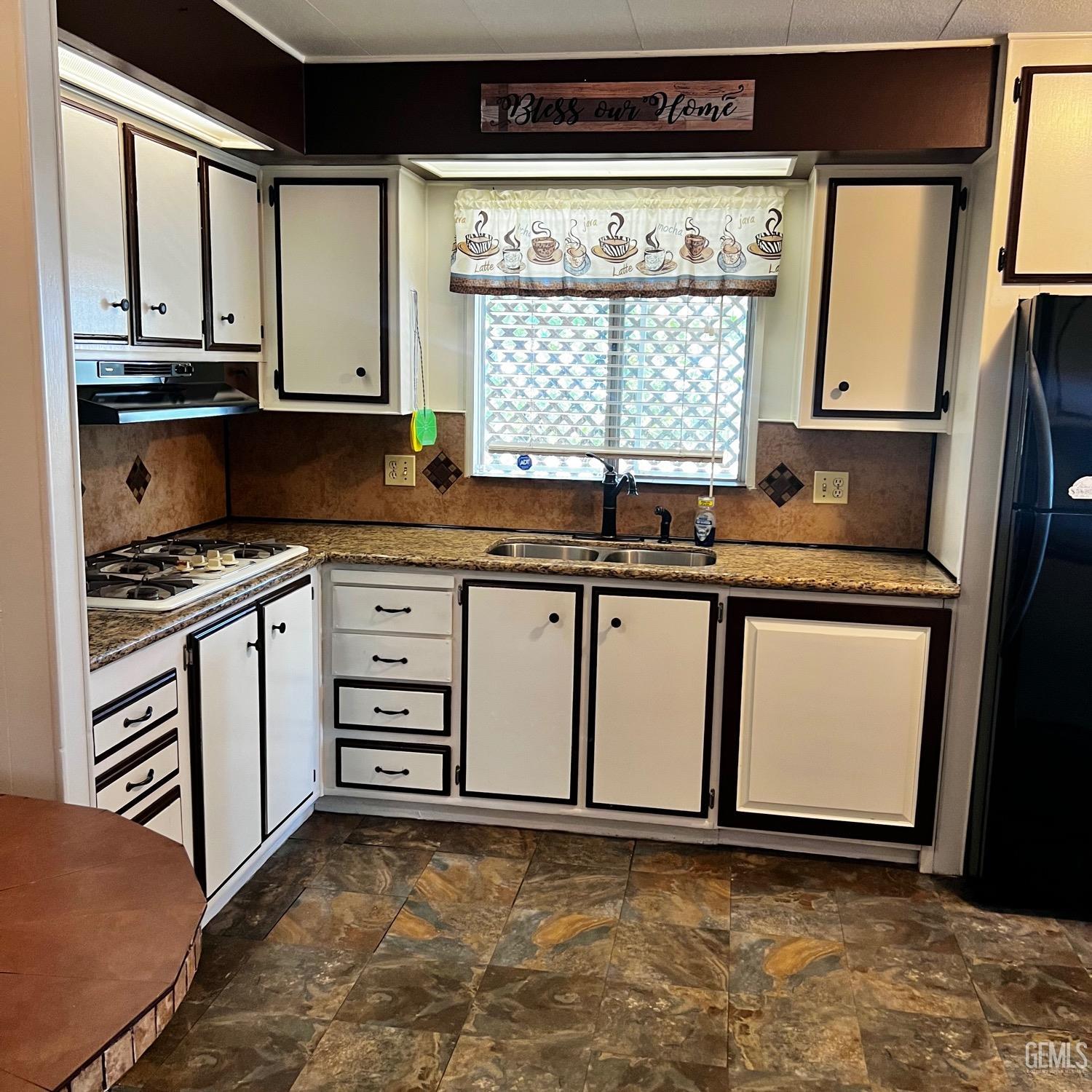 Undisclosed Address Bakersfield, CA 93306 - Photo 3 of 9 a kitchen with stainless steel appliances granite countertop a stove a sink and a microwave