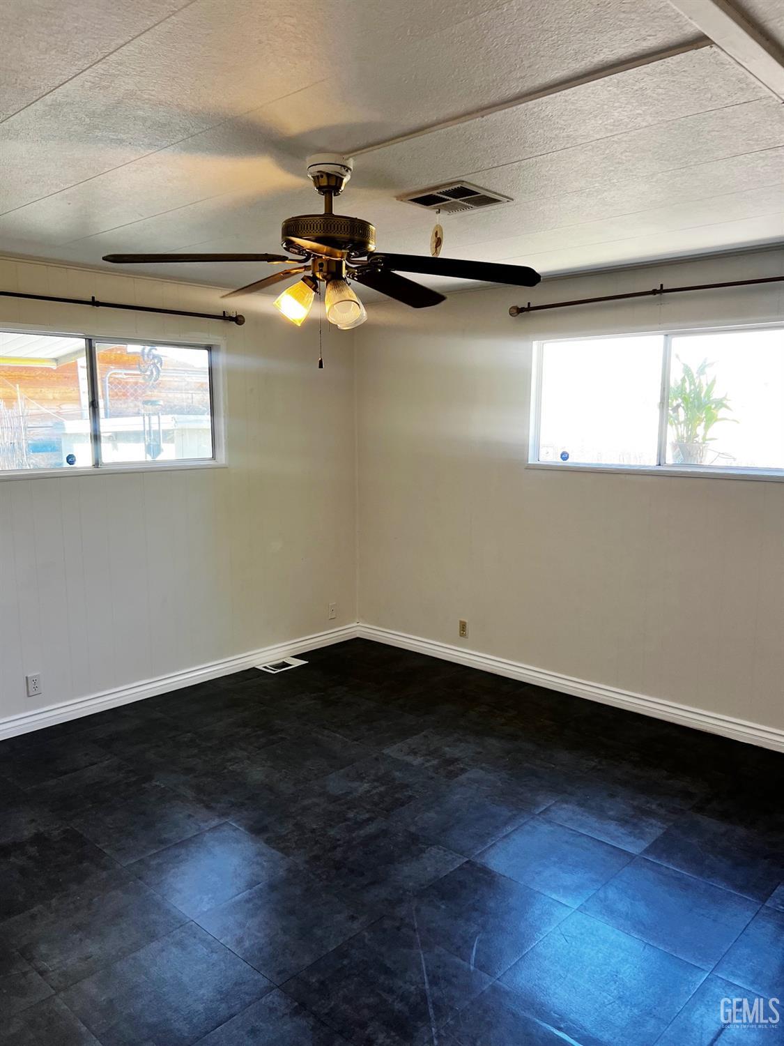 Undisclosed Address Bakersfield, CA 93306 - Photo 4 of 9 a view of an empty room with wooden floor and a window