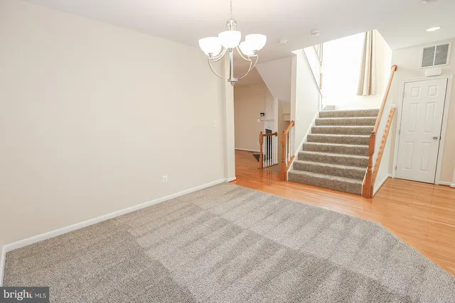 wooden floor fireplace and windows in an empty room