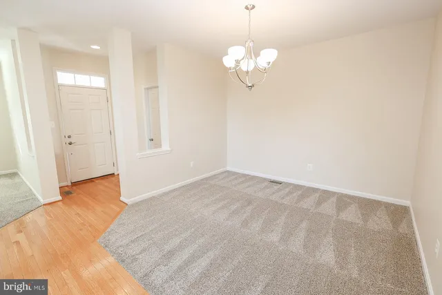 a kitchen with granite countertop a refrigerator stove top oven and sink