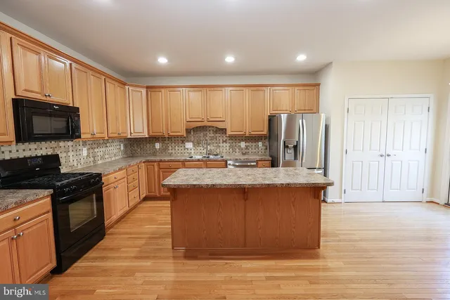 a view of a room with wooden floor and white walls