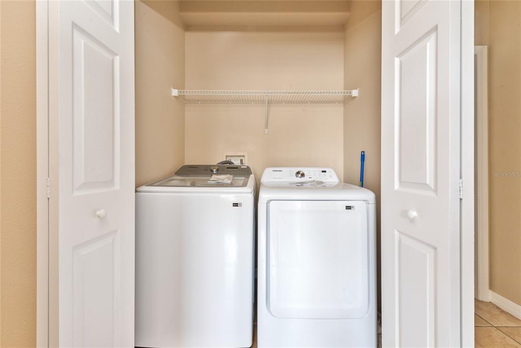 7531 Pellham Way, Unit 77 Kissimmee, FL 34747 - Photo 13 of 28 a utility room with dryer and washer
