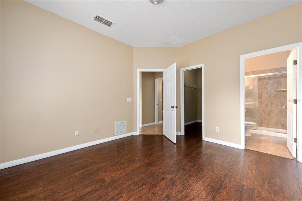 7531 Pellham Way, Unit 77 Kissimmee, FL 34747 - Photo 17 of 28 a view of an empty room with wooden floor