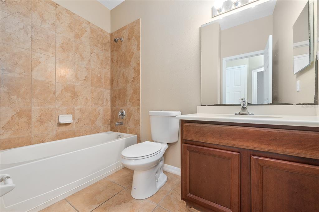 7531 Pellham Way, Unit 77 Kissimmee, FL 34747 - Photo 18 of 28 a bathroom with a sink a toilet and a bathtub