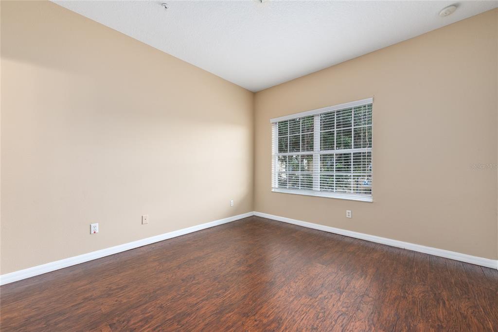 7531 Pellham Way, Unit 77 Kissimmee, FL 34747 - Photo 19 of 28 an empty room with wooden floor and windows