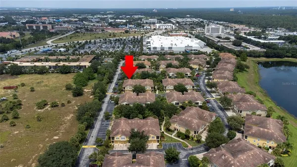 an aerial view of a house with a yard
