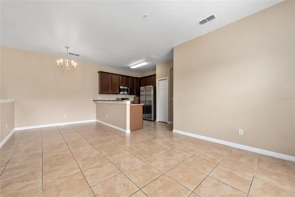 a view of a kitchen with a sink and a refrigerator