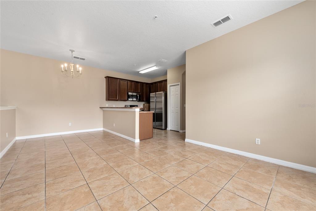 7531 Pellham Way, Unit 77 Kissimmee, FL 34747 - Photo 10 of 28 a view of a kitchen with a sink and a refrigerator