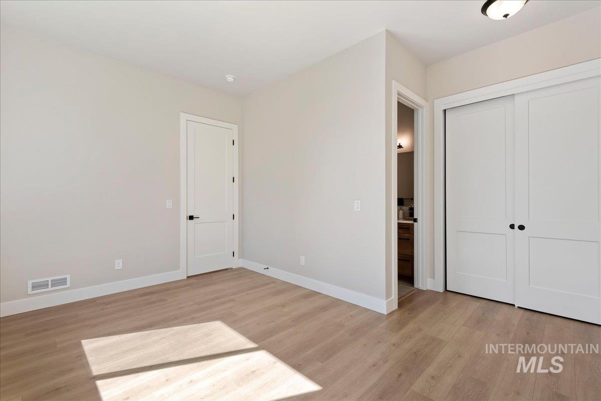 901 West Malbar Street Meridian, ID 83646 - Photo 19 of 33 Unfurnished bedroom featuring light wood-style floors and a closet