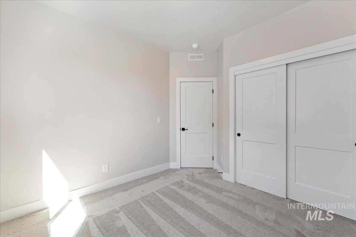 901 West Malbar Street Meridian, ID 83646 - Photo 22 of 33 Unfurnished bedroom featuring light carpet and a closet