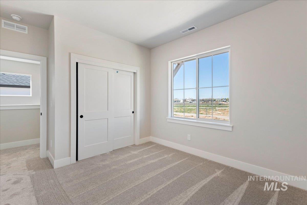 901 West Malbar Street Meridian, ID 83646 - Photo 25 of 33 Unfurnished bedroom with light carpet and a closet
