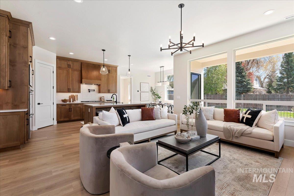 901 West Malbar Street Meridian, ID 83646 - Photo 6 of 33 Living area featuring plenty of natural light, a chandelier, and light wood-style floors