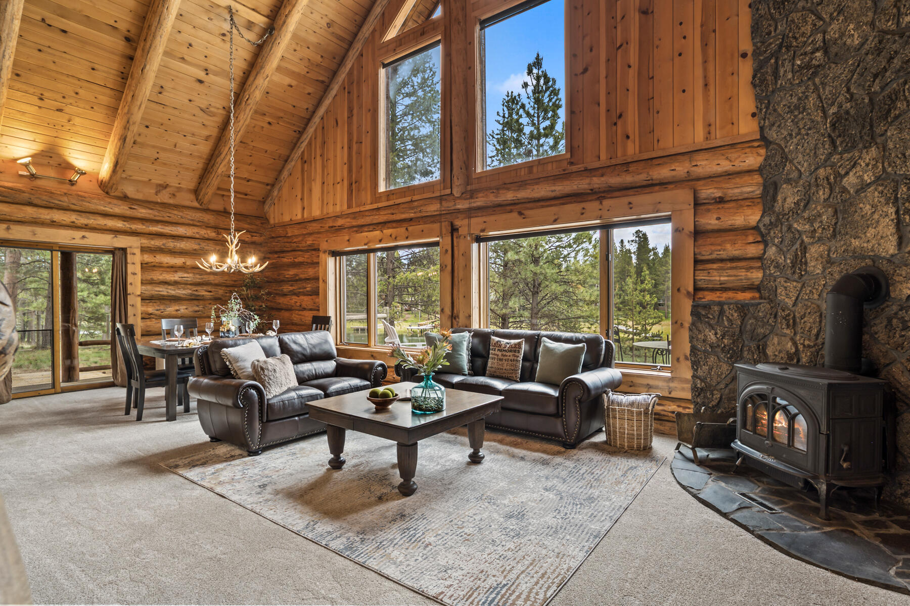 17026 Sharp Drive Bend, OR 97707 - Photo 23 of 72 a living room with furniture a fireplace and a floor to ceiling window