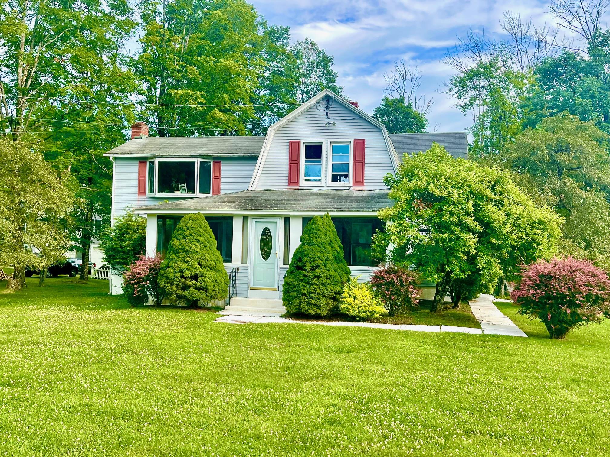 a front view of a house with a yard
