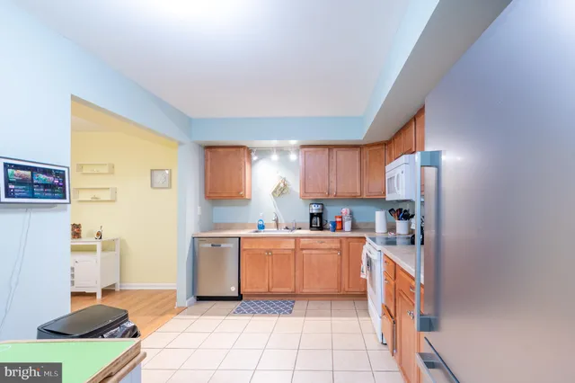 a kitchen with a sink window and cabinets