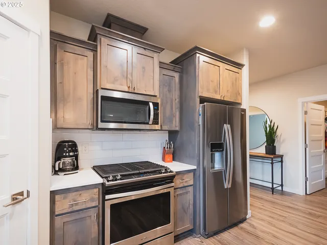 a kitchen with a refrigerator stove and microwave
