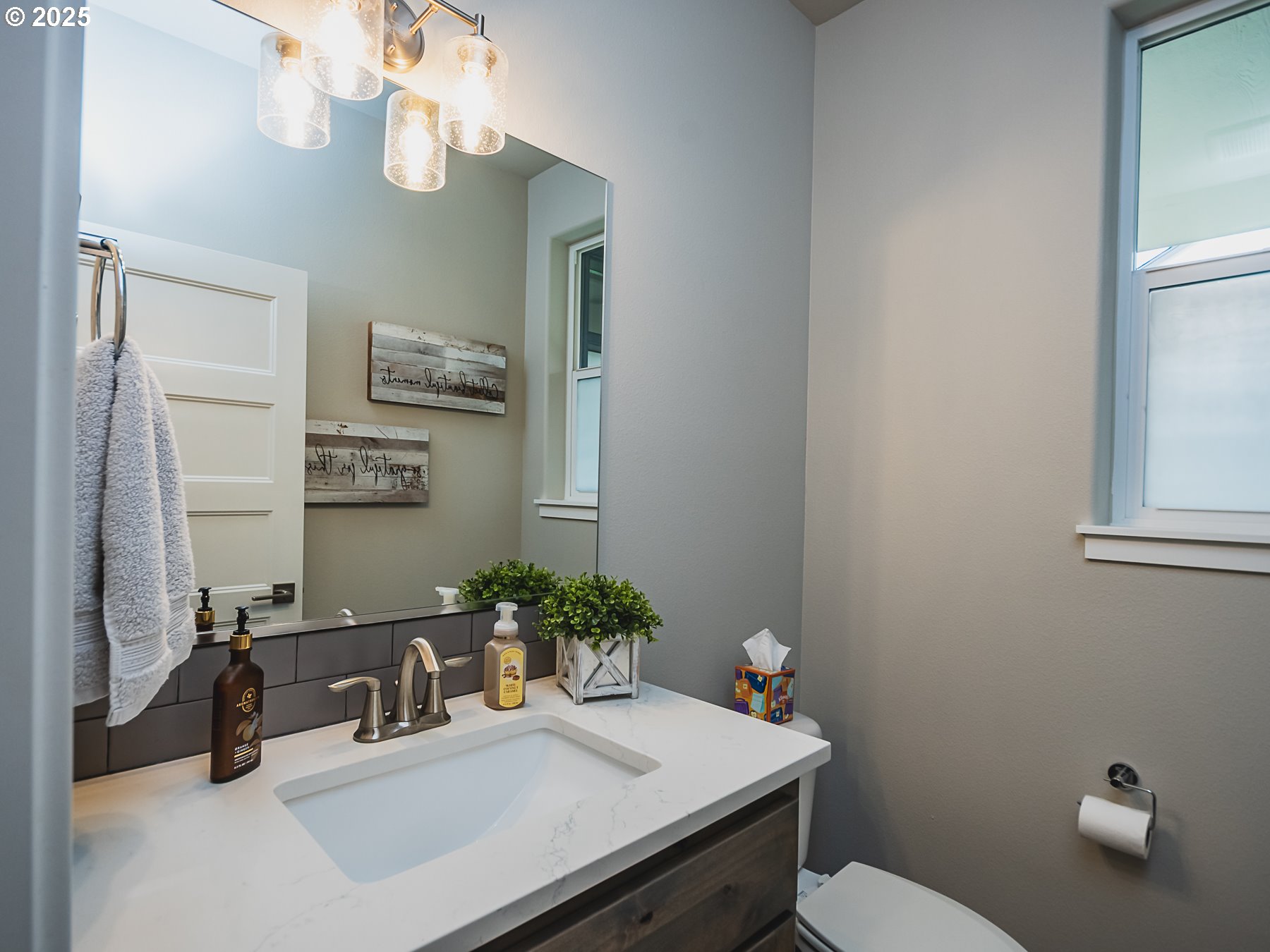 2116 North 3rd Way Ridgefield, WA 98642 - Photo 23 of 40 a bathroom with a sink a toilet and mirror