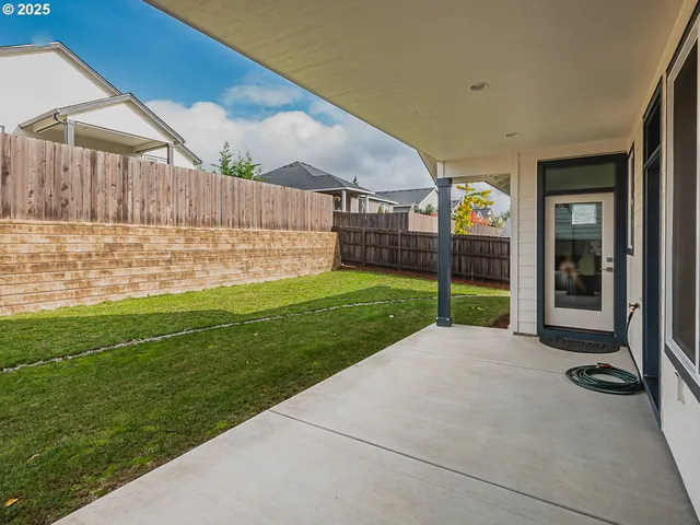 a view of a house with a yard and sitting area
